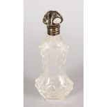 A SHAPED CRYSTAL SCENT BOTTLE with silver top. 5ins long.