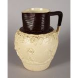 A TURNERS JUG decorated with cupids and fruiting vines. Impressed TURNER. 9ins high.
