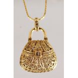 A LOVELY GOLD DIAMOND SET HANDBAG PENDANT AND CHAIN.