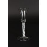 A GEORGIAN WINE GLASS with opaque twist stem and inverted bell bowl. 6.5ins high.