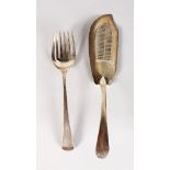 A GEORGE III FISH SLICE, London 1803, Maker: Ely & Fearn, and A GEORGE III FORK, London 1797 (2).