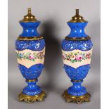 A PAIR OF FRENCH PORCELAIN AND ORMOLU LAMP BASES, with a central band of floral decoration on a blue