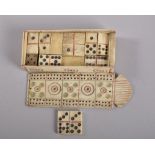 A NAPOLEONIC PRISONER OF WAR BONE SET OF DOMINOES and a case. 10cms long.