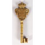 A CAST BRONZE GERMAN KEY with crest. 8ins long.