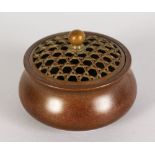 A LARGER CHINESE BRONZE CIRCULAR CENSER with pierced lid. 2.5ins.