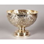 A VICTORIAN CIRCULAR PUNCH BOWL, repousse with scrolls and flowers. 10.5ins diameter. London 1888.