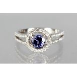 AN 18CT WHITE GOLD, TANZANITE AND DIAMOND HALO STYLE RING of 1.25cts.