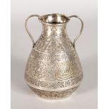 AN ISLAMIC SILVER TWO HANDLED VASE. 4.5ins high.