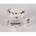 A TINY SILVER NOVELTY ROCKING HORSE.