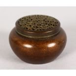 A MINIATURE CHINESE BRONZE CIRCULAR CENSER with pierced lid. 1.5ins.
