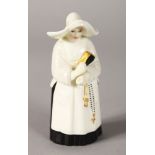 A ROYAL WORCESTER CANDLE SNUFFER "THE NUN". 3.5ins high.