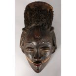 A PAINTED TRIBAL MASK with real hair. 13ins long.