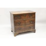 A SMALL 18TH CENTURY OAK STRAIGHT FRONT CHEST of three long graduated drawers with brass handles and