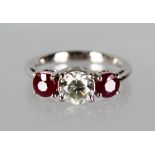 AN 18CT WHITE GOLD, RUBY AND DIAMOND RING, the central diamond of 95 points, flanked by two rubies.
