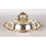 AN OVAL SHAPED TUREEN AND COVER with shell and foliate borders.