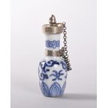 A MINIATURE DELFT BLUE AND WHITE PORCELAIN PERFUME BOTTLE with silver stopper, ring and chain. 4.