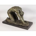 A BRONZE ABSTRACT FIGURE, of a man kneeling and leaning forward. 2ft 1ins long.