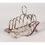 A VICTORIAN SHAPED SIX DIVISION TOAST RACK on claw and ball feet. London 1898.