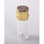 A SUPERB CLEAR CUT CRYSTAL PERFUME BOTTLE, FRENCH, CIRCA. 1900, the gold top inlaid with rubies