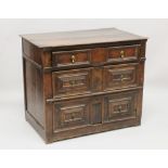 A 17TH CENTURY OAK STRAIGHT FRONT CHEST of three long drawers with brass drop handles. 3ft 2ins