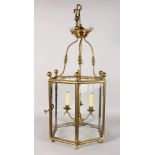 A GOOD HEXAGONAL BRASS HANGING LANTERN with single door and three hanging lights. 30ins high.