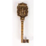 A CAST BRONZE GERMAN KEY with crest. 8ins long.