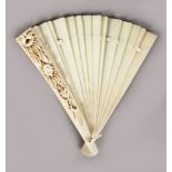 A EUROPEAN IVORY FAN, carved with doves, birds nest and eggs, rope and wheat ears. 14ins open.