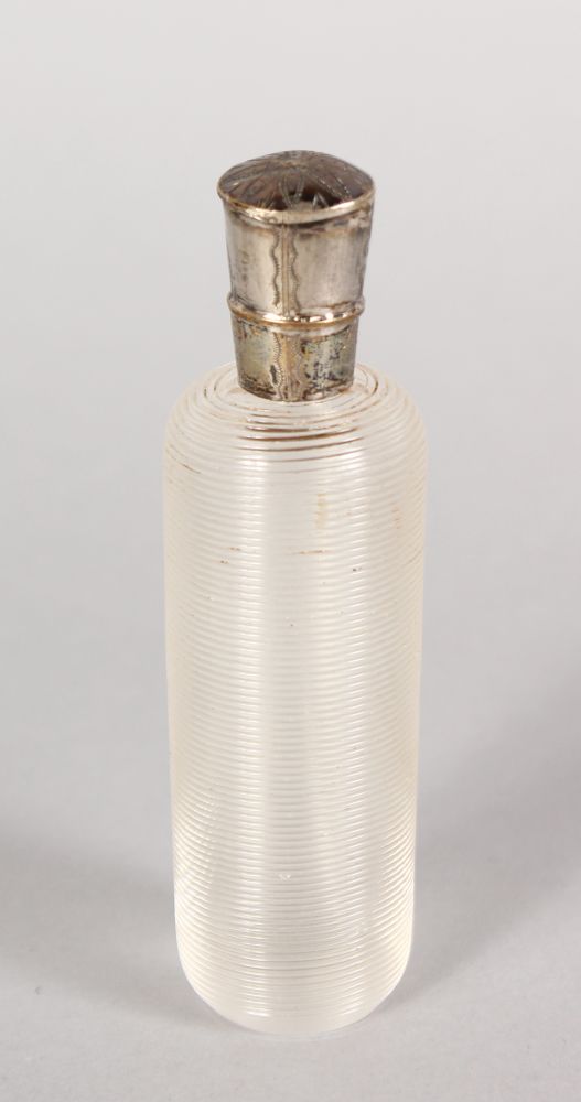 A CUT CRYSTAL FRENCH SCENT BOTTLE with silver top. 3.5ins long.
