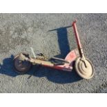 OLD RED SCOOTER , WOODEN HANDLES, METAL WHEELS WITH CHAIN, BELIEVED TO BE AN EARLY HARRODS