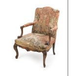 A French carved walnut fauteuil a la reine