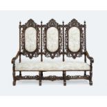 A Jacobean-style carved high-back settee