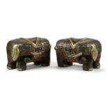 A pair of carved Chinese gilt and painted elephant seats