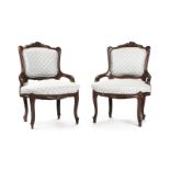 A pair of Louis XV-style carved wood armchairs