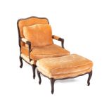 A French-style carved wood fauteuil and ottoman