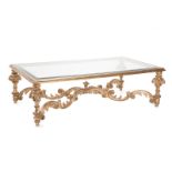 A carved giltwood and glass coffee table