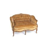 A Louis XV-style carved wood loveseat