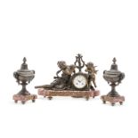 A patinated spelter mantel clock and garniture