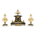 An Egyptian revival mantel clock and garniture