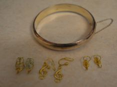 3 pairs of 9ct gold slip on earrings and a silver bangle