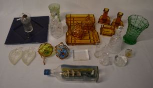 Glassware including a small decanter, ship in a bottle,