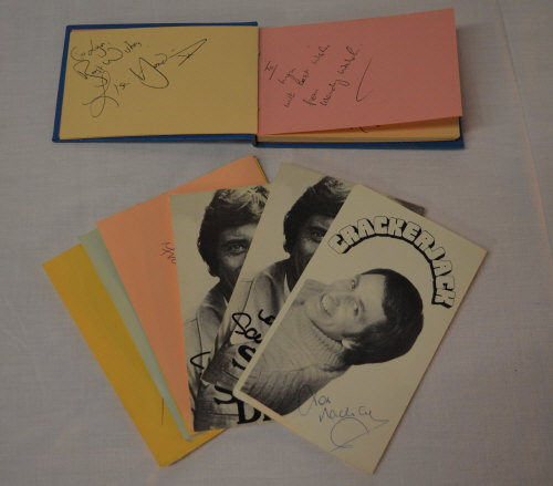 Small autograph book part containing signatures and photographs including signature of Leslie