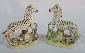 Pair of reproduction Staffordshire Zebras (one with firing crack on stump)