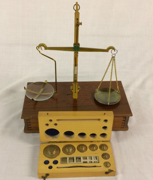 Balance scale set on wooden base & a box of weights