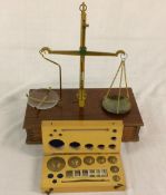 Balance scale set on wooden base & a box of weights