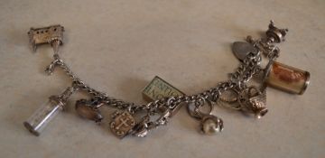 White metal charm bracelet with a quantity of charms,
