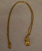 Oriental tested as 15ct gold necklace with a tested as 9ct gold pendant in the shape of a small cat,