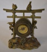 Oriental style brass clock in the style of a hanging gong with climbing dragons and birds