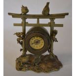 Oriental style brass clock in the style of a hanging gong with climbing dragons and birds