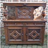 17th century style court cupboard with geometric paneling & a small brass plaque inscribed