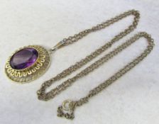 9ct gold pendant with synthetic purple stone on a yellow metal chain
